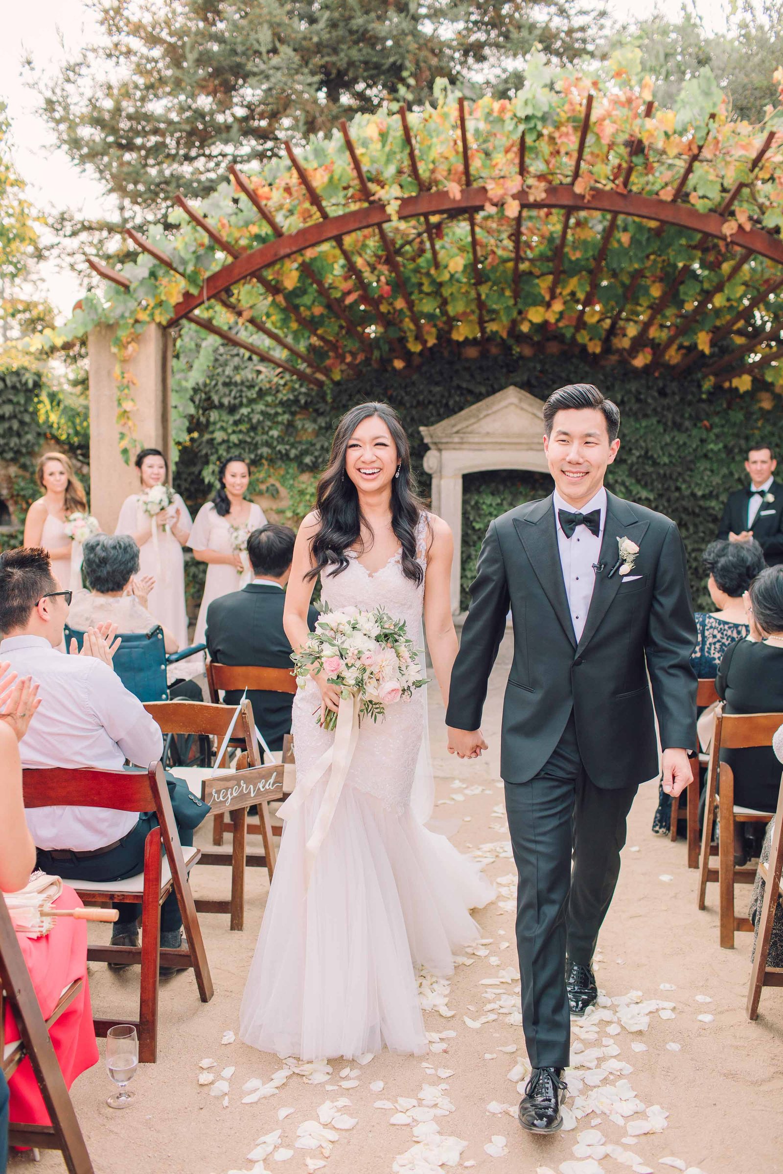 seven branches grroom and bride hapily walking down the aisle