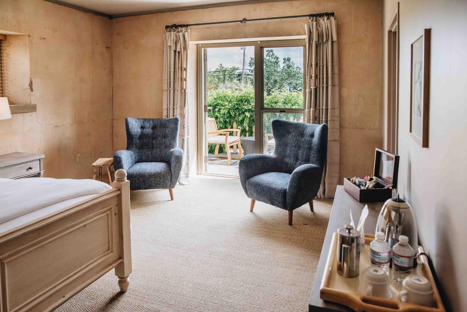 Hotel Room With Open Doors That Lead To A Patio